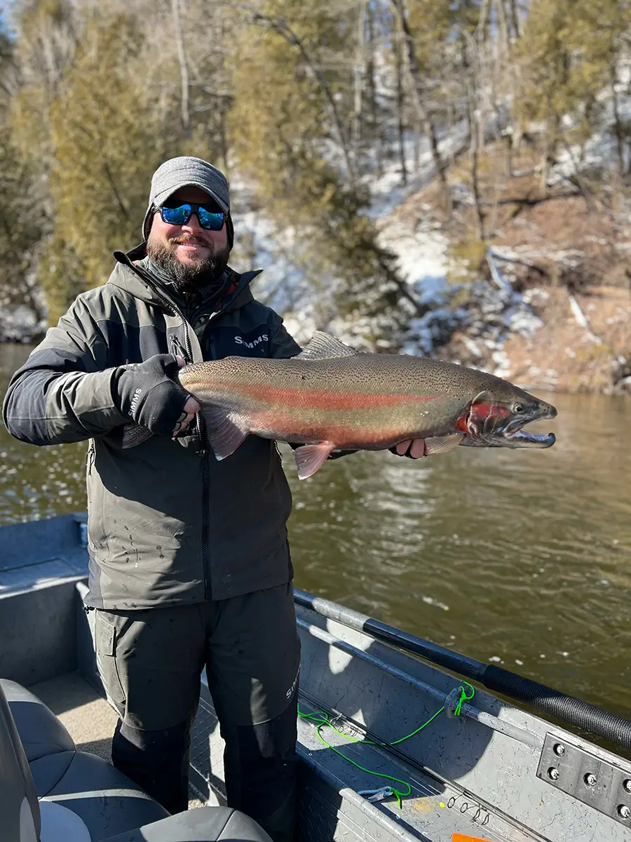 Close up of Captain Jesse holding a trout
